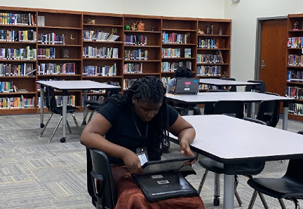 Students working on a project at tables in the Media Center