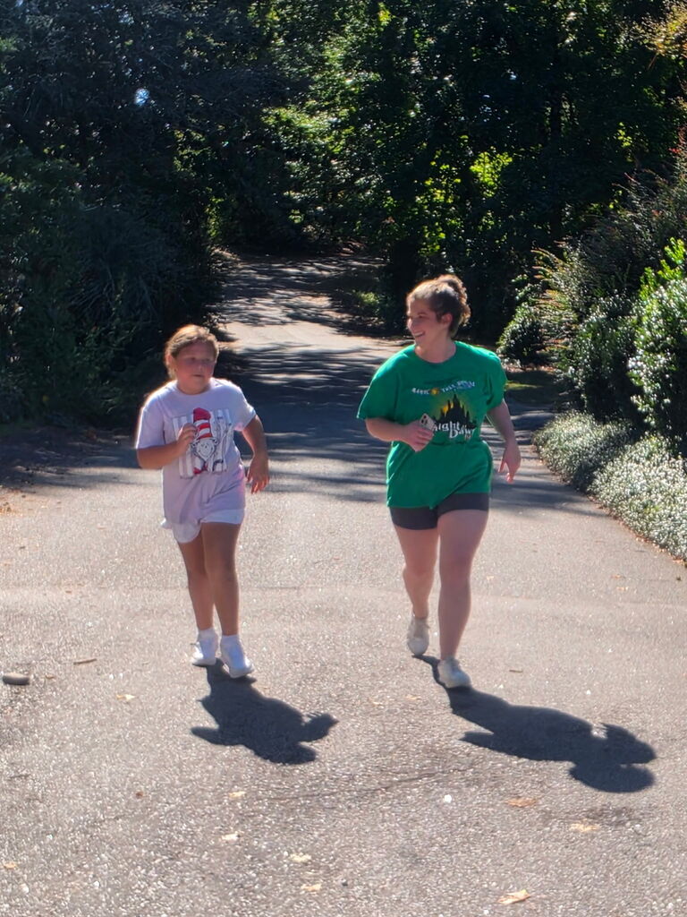 Students on our Run Hard Team running down the road