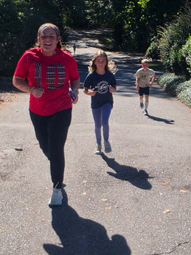 Students on our Run Hard Team running down the road