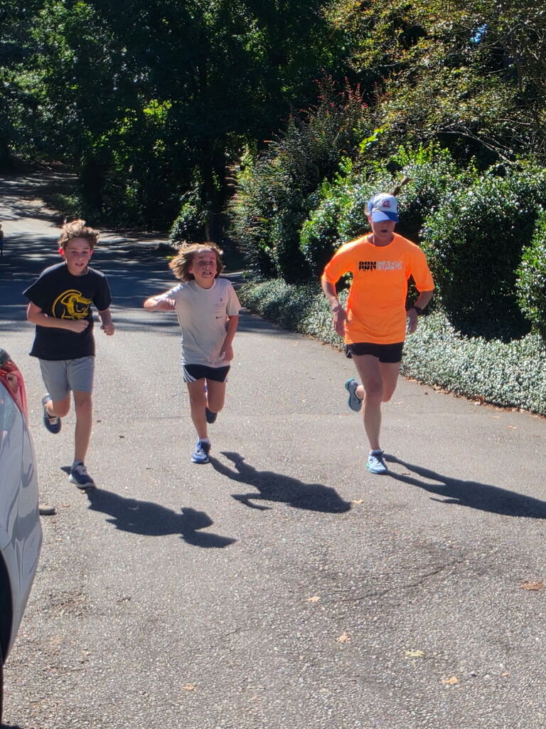 Students on our Run Hard Team running down the road