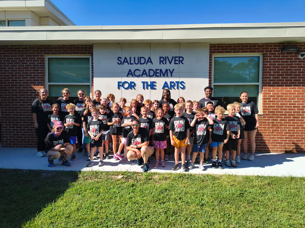 Students on our Run Hard Team running down the road