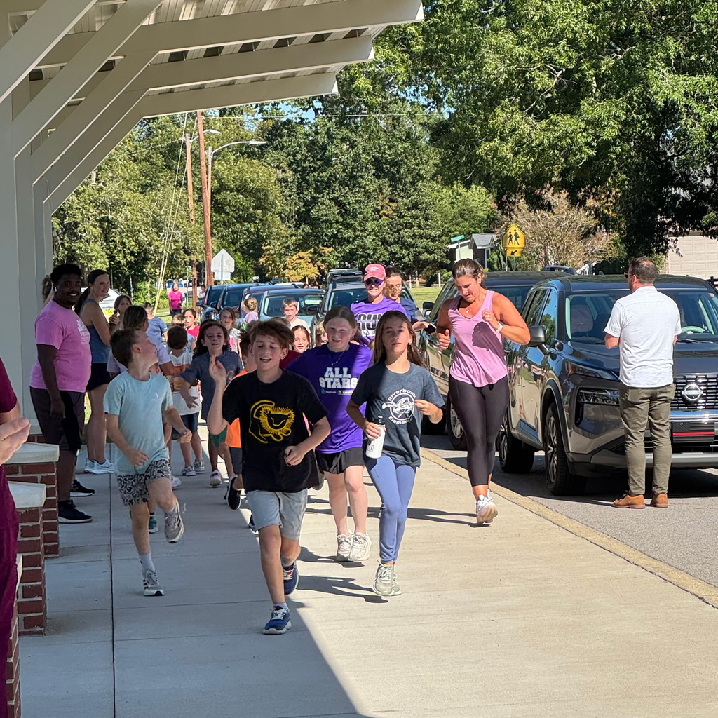 Students on our Run Hard Team running down the road