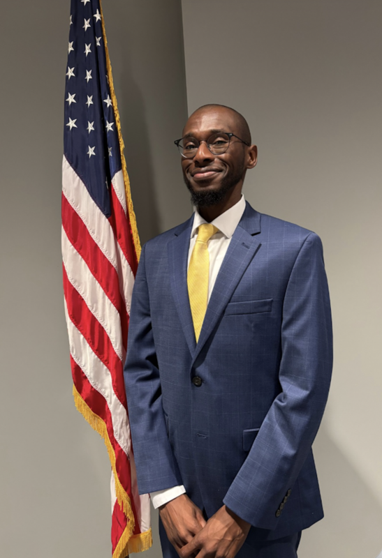 Dr. Johnathan Abney in front of a US flag