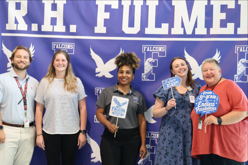 5 members of Fulmer's Future Ready Advisory Council post in front of a blue Fulmer backdrop