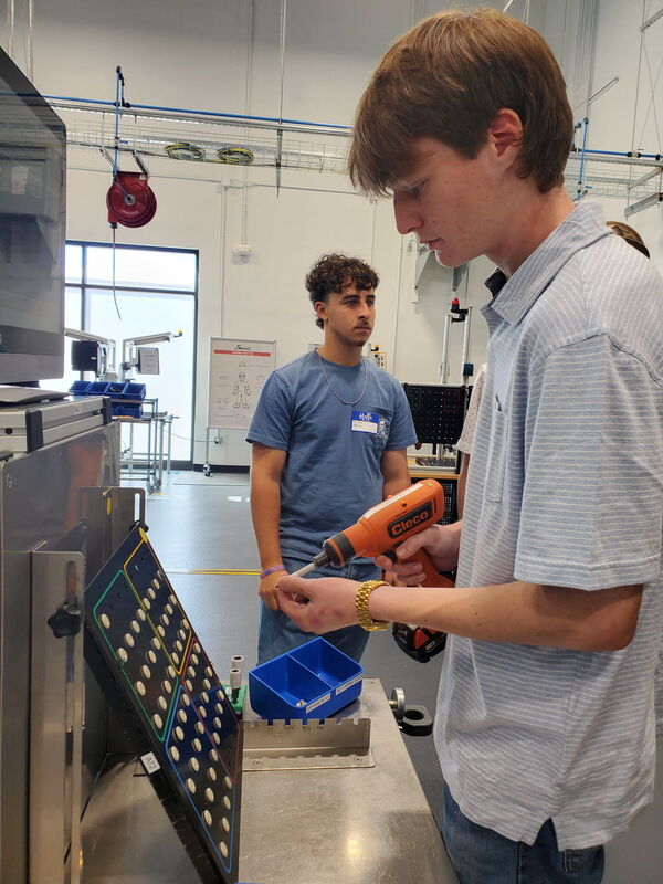 L2IC student Reece Caughman participates in one of the hands-on activities at Scout Motors