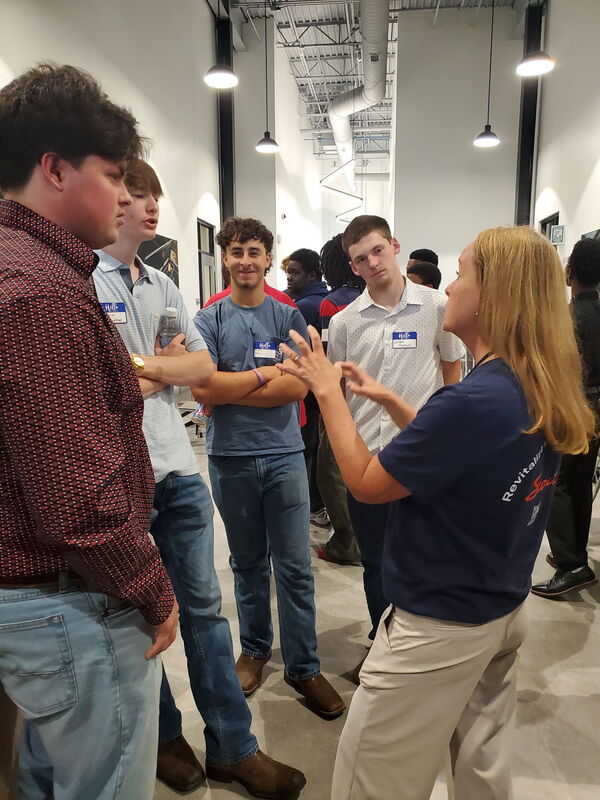 L2IC students listen to an employee with Scout Motors