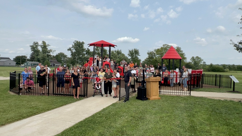 Group picture on the playground while cutting the ribbon for Selma Elementary's inclusive playground