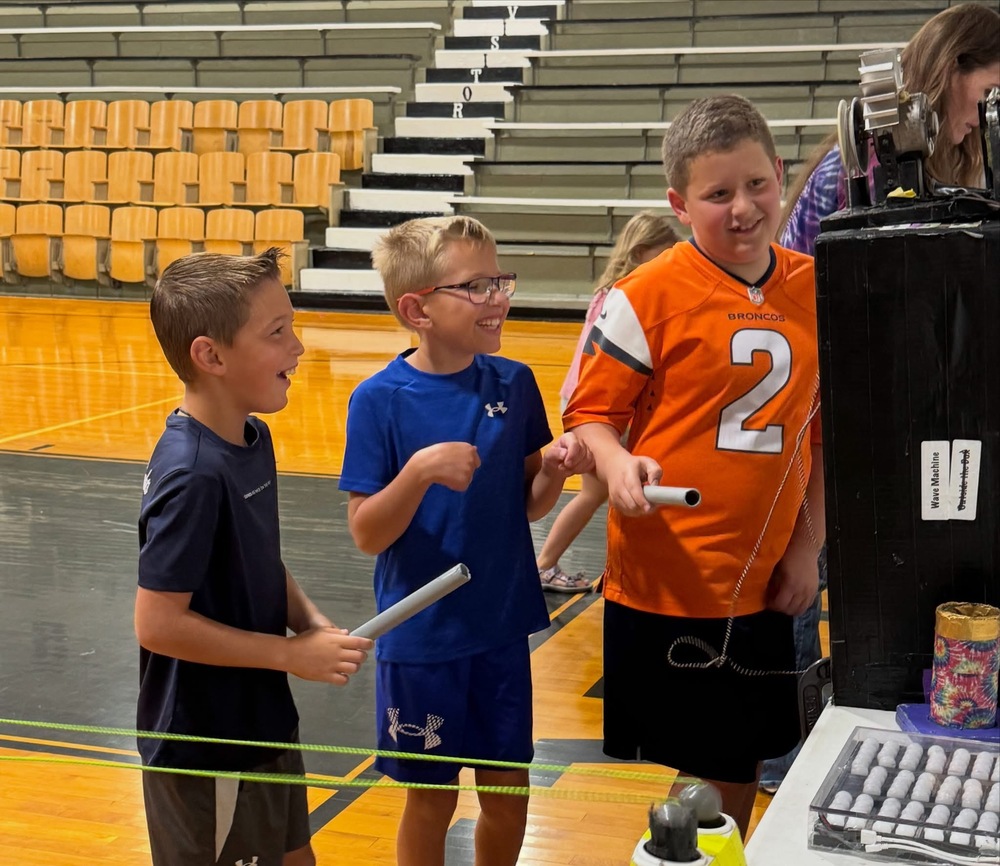 Daxton Hastings, Karston Frank, and Weston Mann participate in one of the many projects Little Shop of Physics featured.