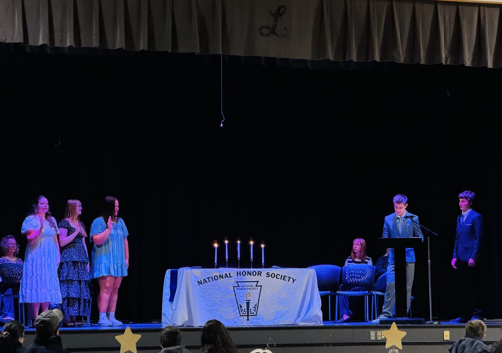 Inductees to the Liberty Chapter of the National Honor Society recite the Pledge to uphold the four main pillars of the organization: Scholarship, Service, Leadership, and Character.
