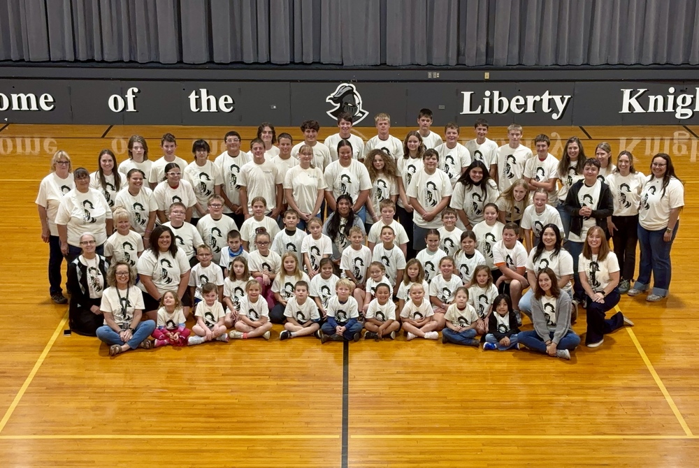 Students and staff pose for a picture in their new Liberty shirts - sporting the "Legacy Lives On"