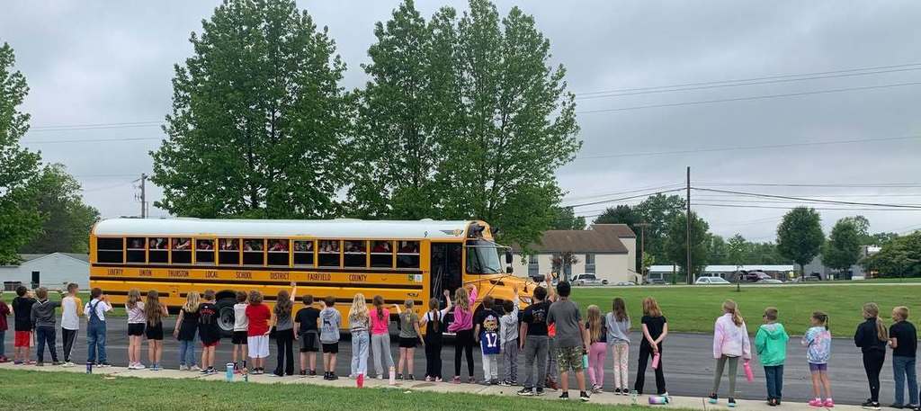 Elementary students cheering on the Lady Lions softball team as they advance to the OHSAA Regional Semifinals at Centerville softball stadium.
