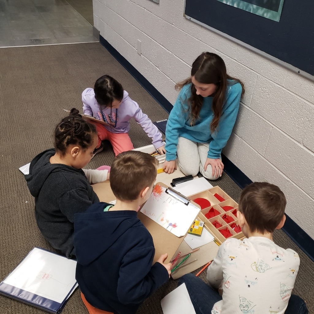 Student teaching a skill back to others