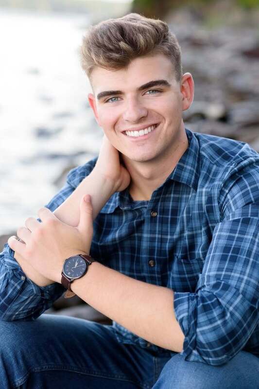 boy in blue plaid shirt smiling for photo