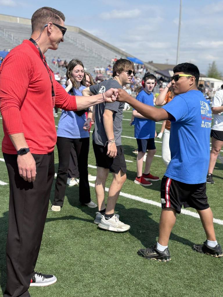 Elkmont High School Principal Graham Aderholt congratulates a student athlete after finishing an event at Special Olympics.
