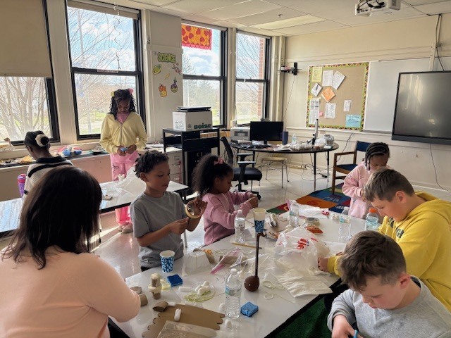 Students creating parachutes for an egg drop challenge