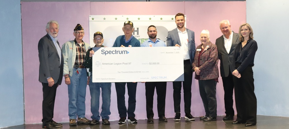 Veterans and elected officials hold a $2,000 check to the American Legion from Spectrum