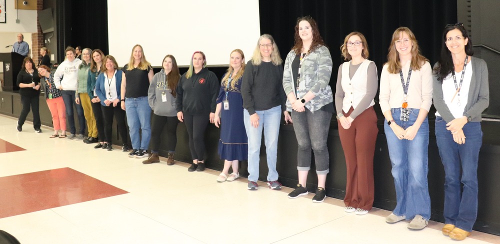 Women standing in front of a stage