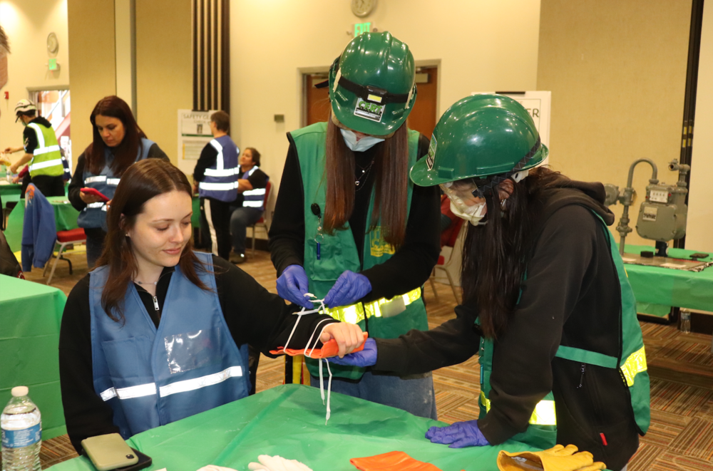 Teen CERT students splint the arm of a volunteer