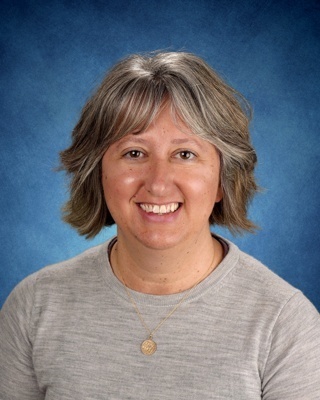 portrait of a woman in a gray sweater with gray hair