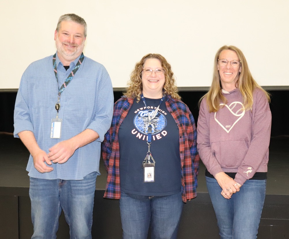 middle aged man blue standing next to two middle aged women