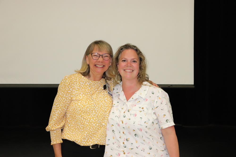 Two middle aged women smiling