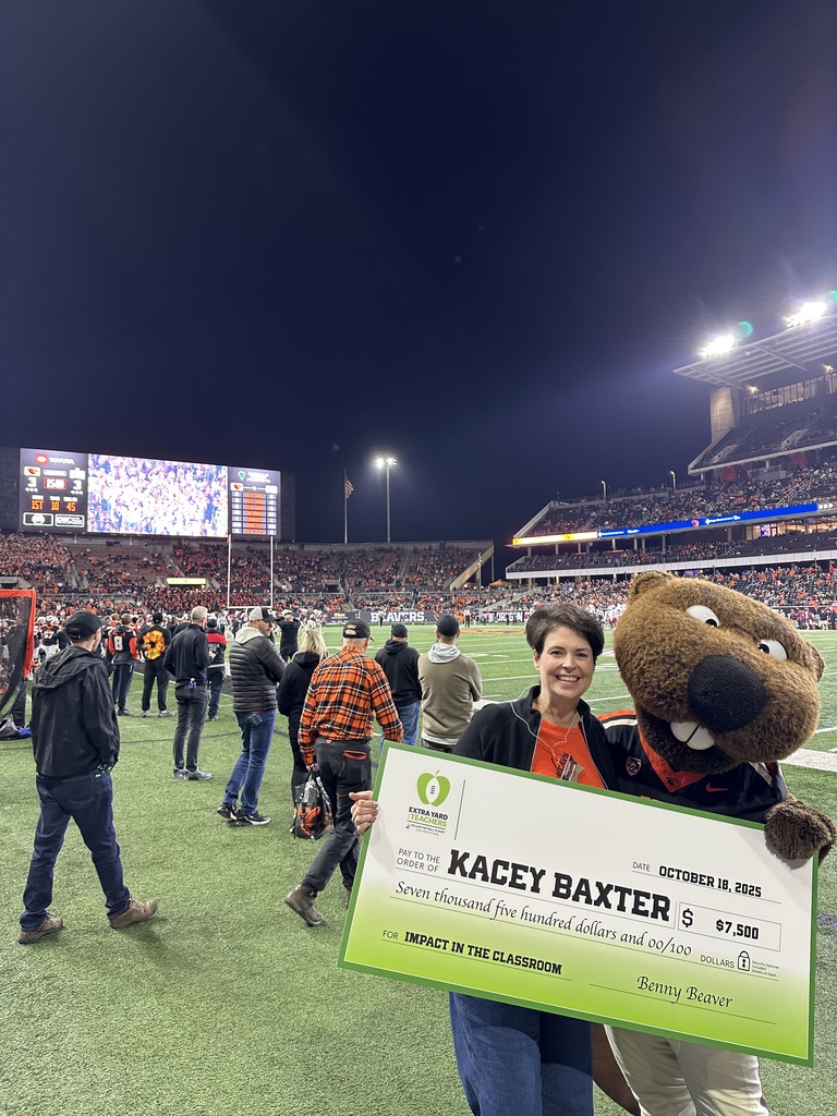 Regional Teacher of the Year Kacey Baxter pictured with Benny Beaver at the Oregon State University Football game.