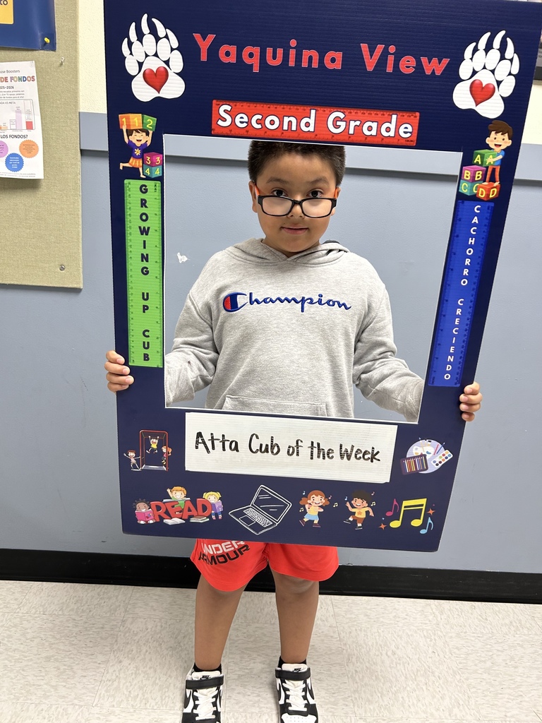 Male student holding up Atta Cub Kid of the Week picture frame.