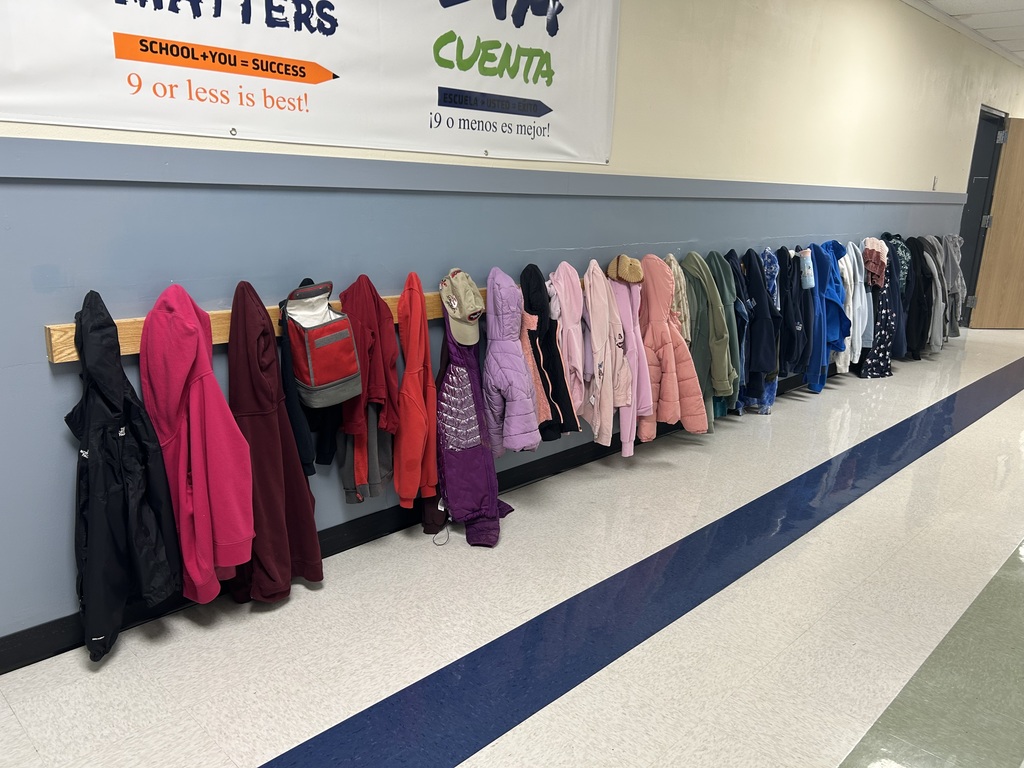 Coats and sweaters hanging in the Yaquina View lost and found.