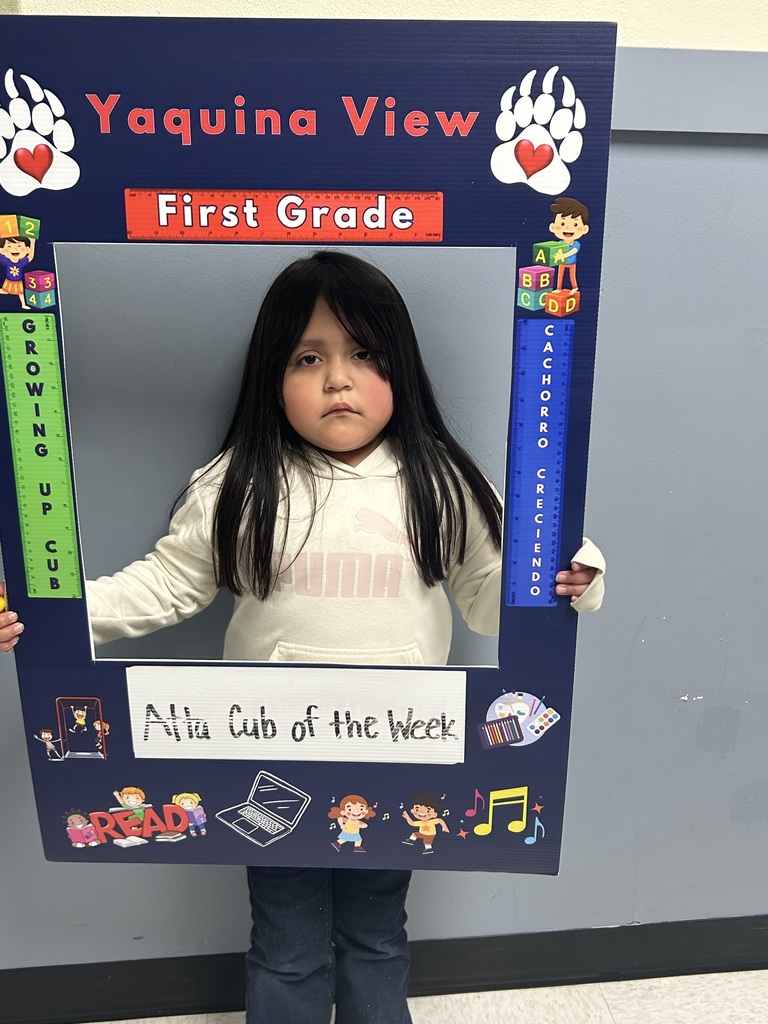 Smiling girl child holding a picture frame saying Atta Cub Kid of the Week