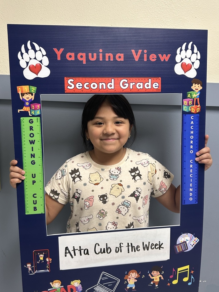 Smiling girl child holding a picture frame saying Atta Cub Kid of the Week