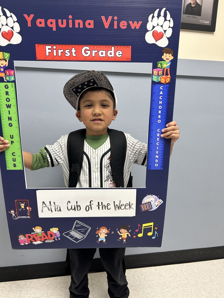Smiling boy holding Atta Cub kid of the Week Frame 