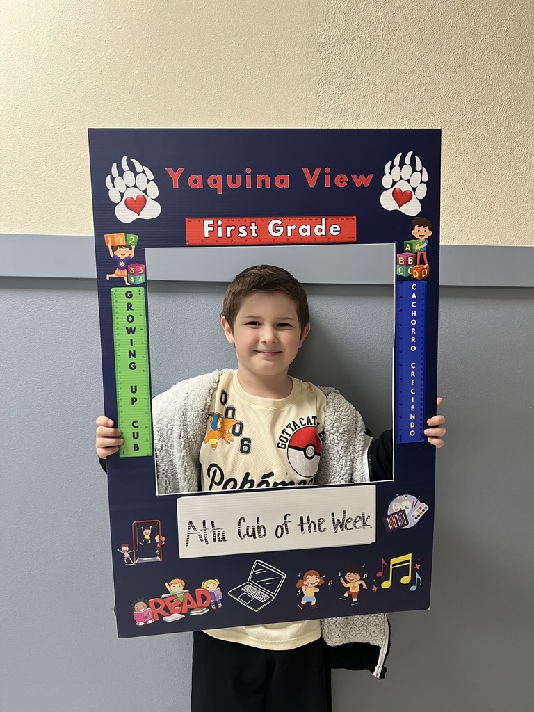 Smiling boy holding Atta Cub Kid of the week picture frame