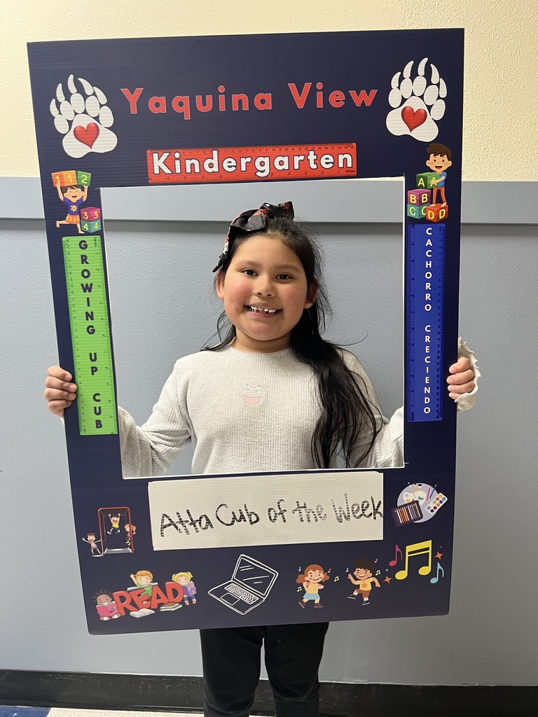 Smiling girl holding Atta Cub Kid of the week picture frame