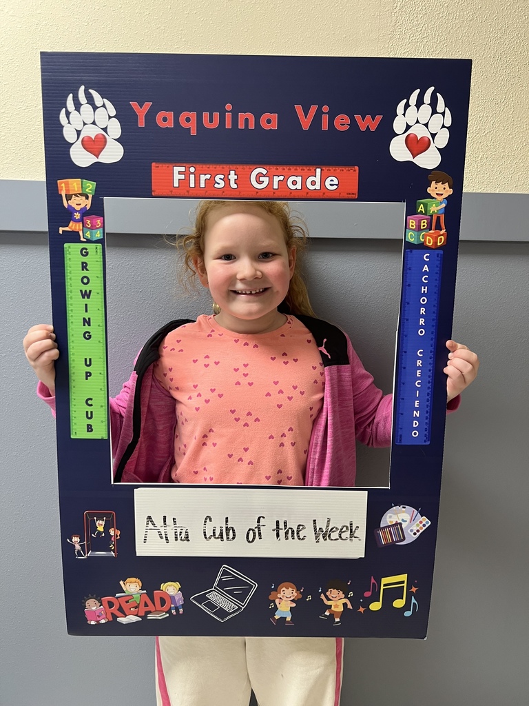 Smiling girl holding Atta Cub Kid of the week picture frame