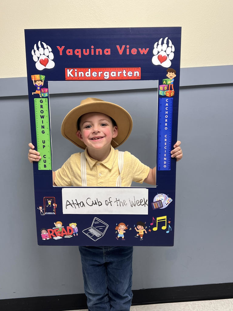 Smiling boy holding Atta Cub Kid of the Week frame.