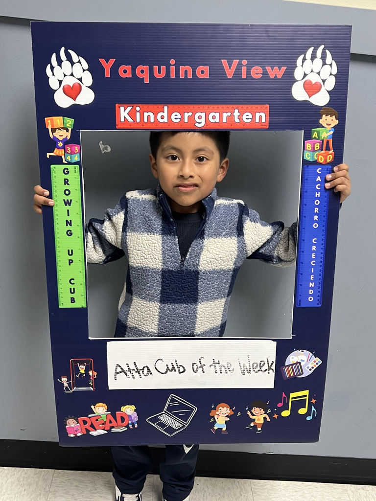 Smiling boy holding Atta Cub Kid of the Week frame.