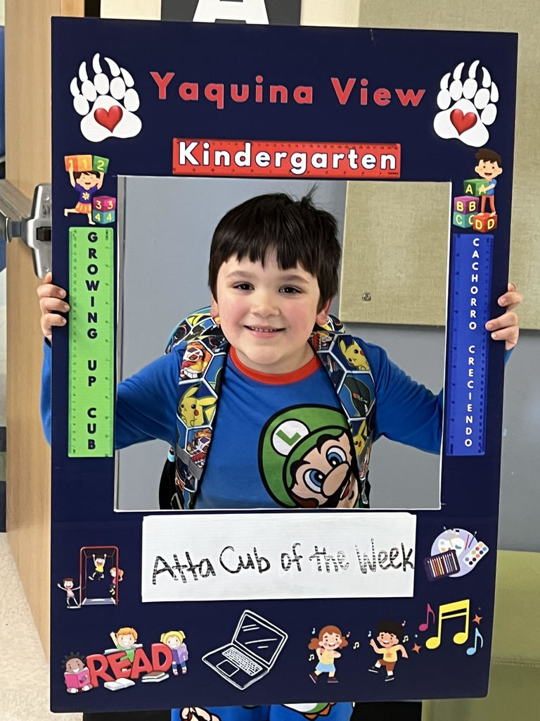 Smiling boy holding Atta Cub Kid of the Week frame.
