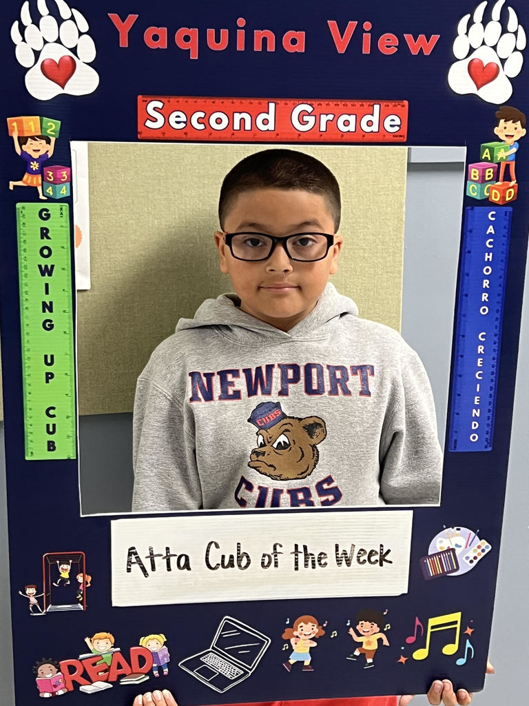Smiling boy holding Atta Cub Kid of the Week frame.