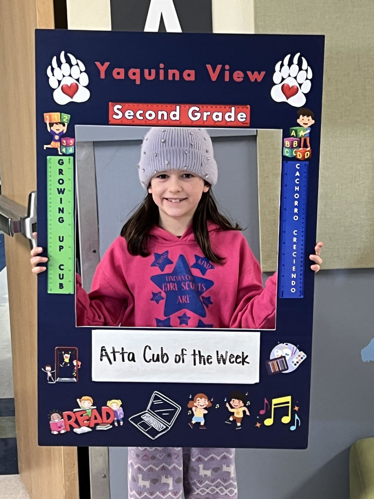 Smiling girl holding Atta Cub Kid of the Week frame.