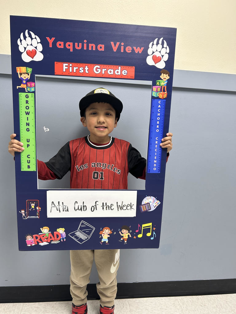 Smiling boy holding Atta Cub Kid o f the week frame