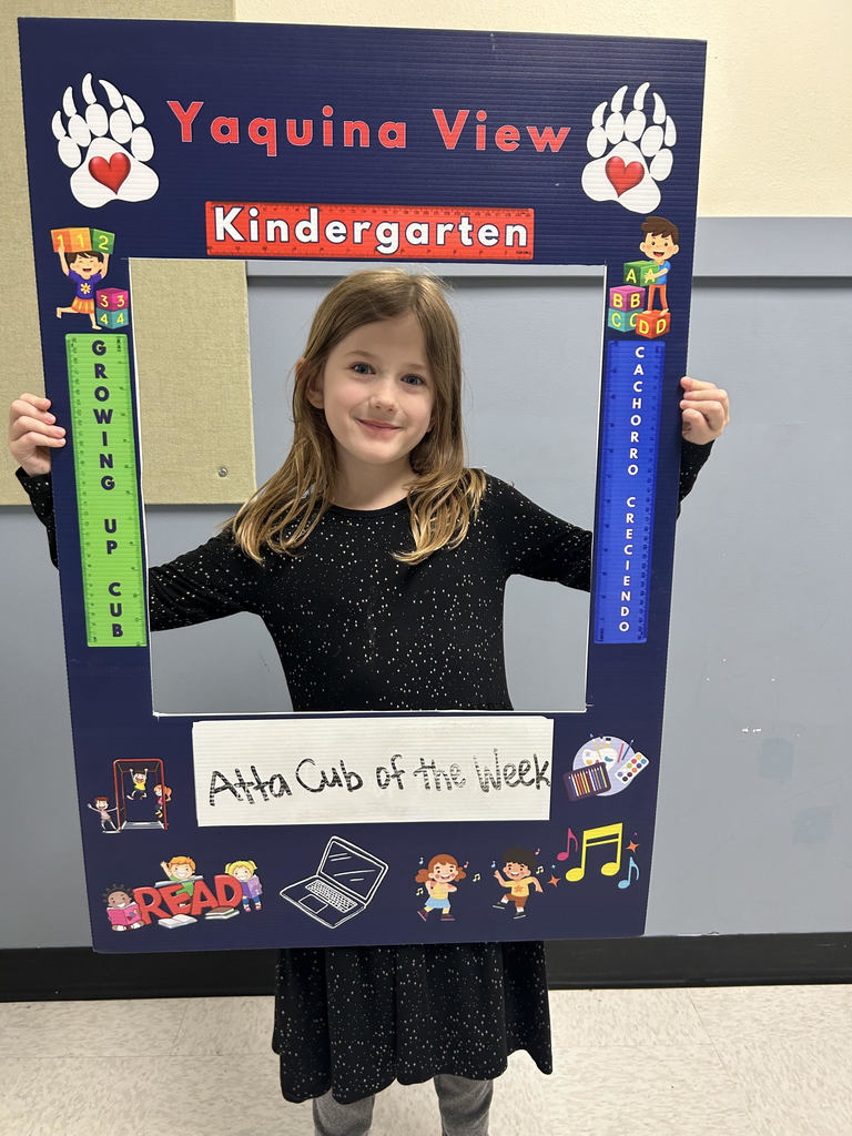 Smiling girl holding Atta Cub Kid o f the week frame