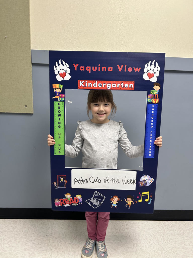 Smiling girl holding Atta Cub Kid o f the week frame