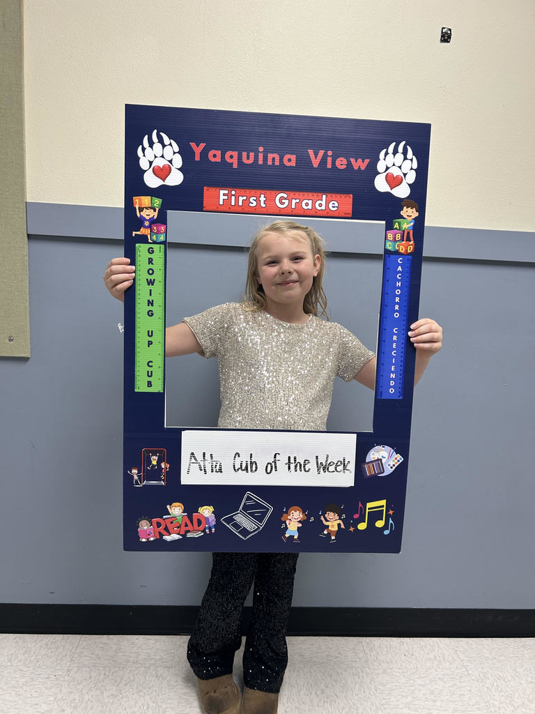 Smiling girl holding Atta Cub Kid o f the week frame