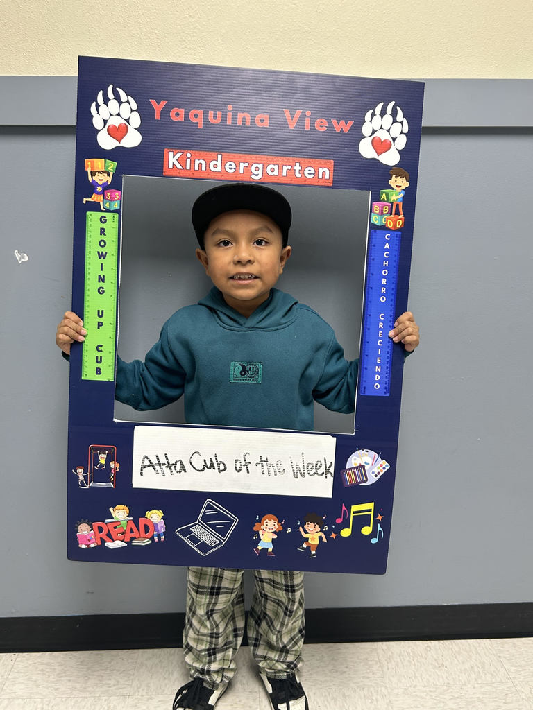 Smiling boy holding Atta Cub kid of the week frame