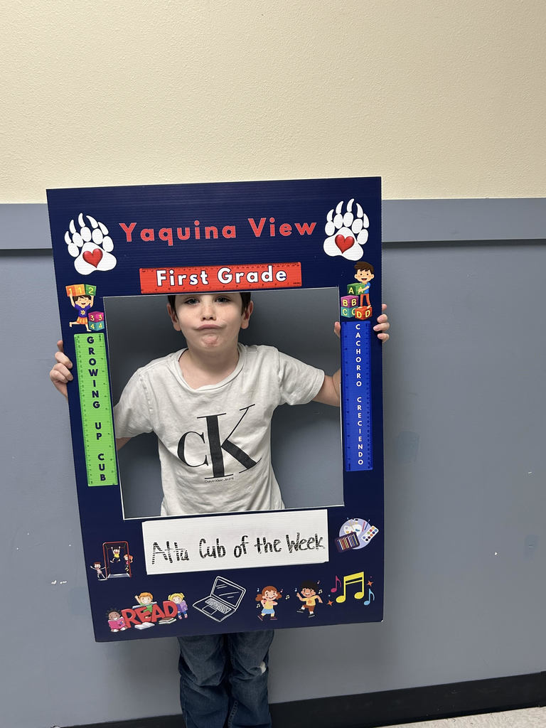 Smiling boy holding Atta Cub kid of the week frame