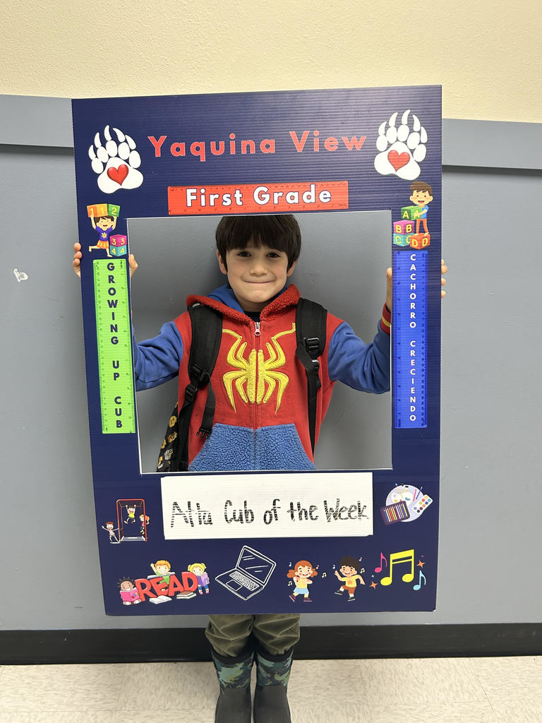 Smiling boy holding Atta Cub kid of the week frame