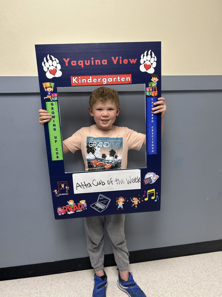 Smiling boy holding Atta Cub Kid of the week frame.