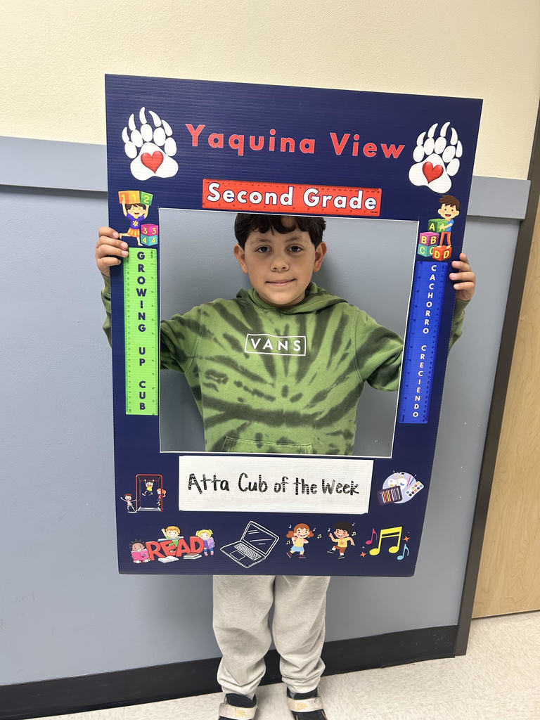 Smiling boy holding Atta Cub Kid of the week frame.