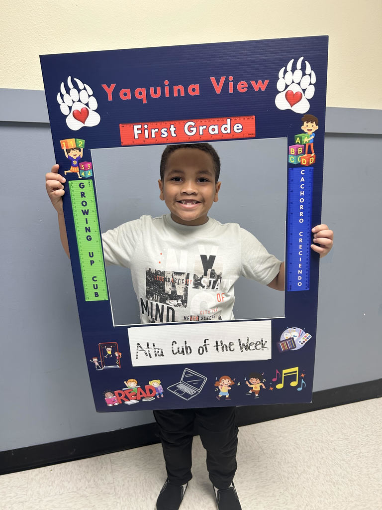 Smiling boy holding Atta Cub Kid of the week frame.