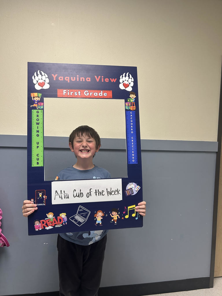Smiling boy holding Atta Cub Kid of the week frame.